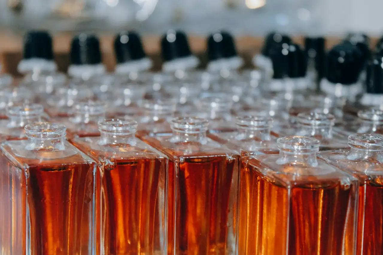 Rows of filled glass bottles on a production line