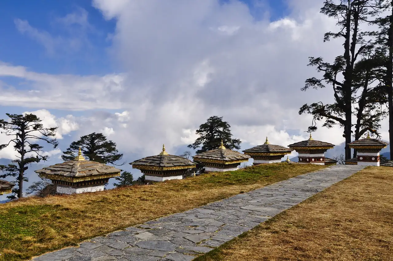 Rows of small white stupas on a mountain pass