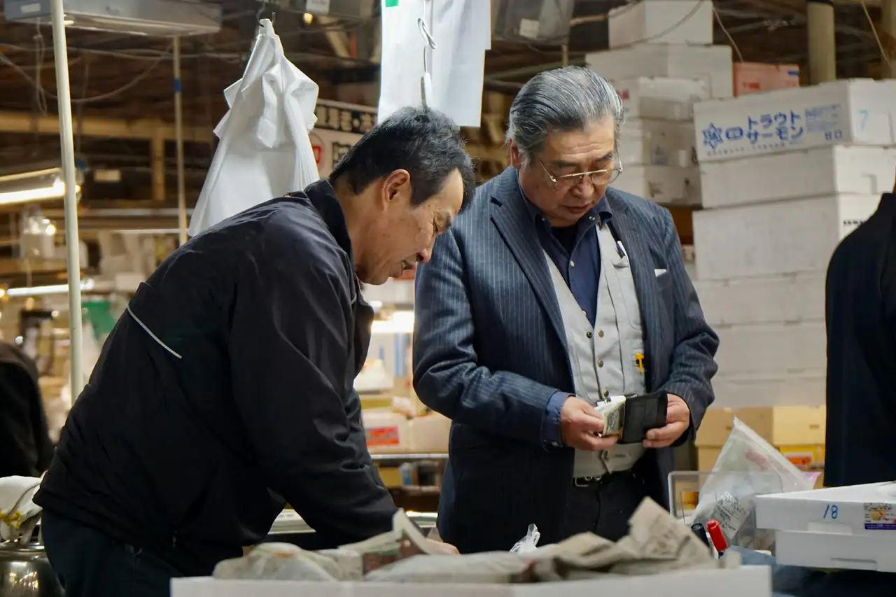 Two men inspecting goods on a factory floor