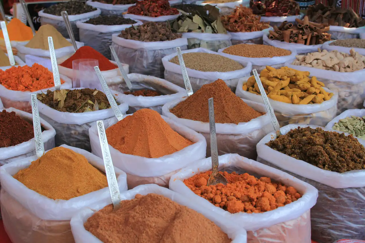 Open sacks of spices and pulses at a market