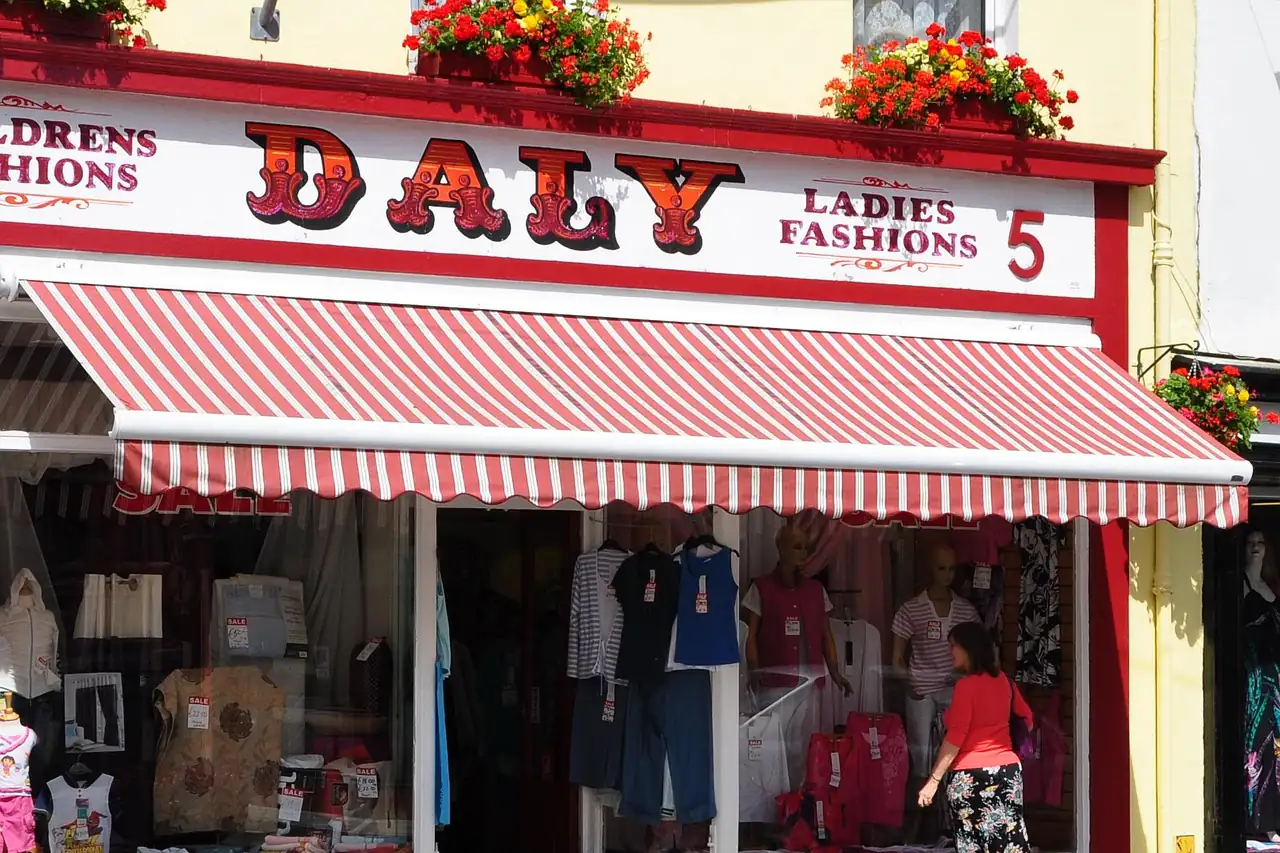 A small clothes shop with a striped awning