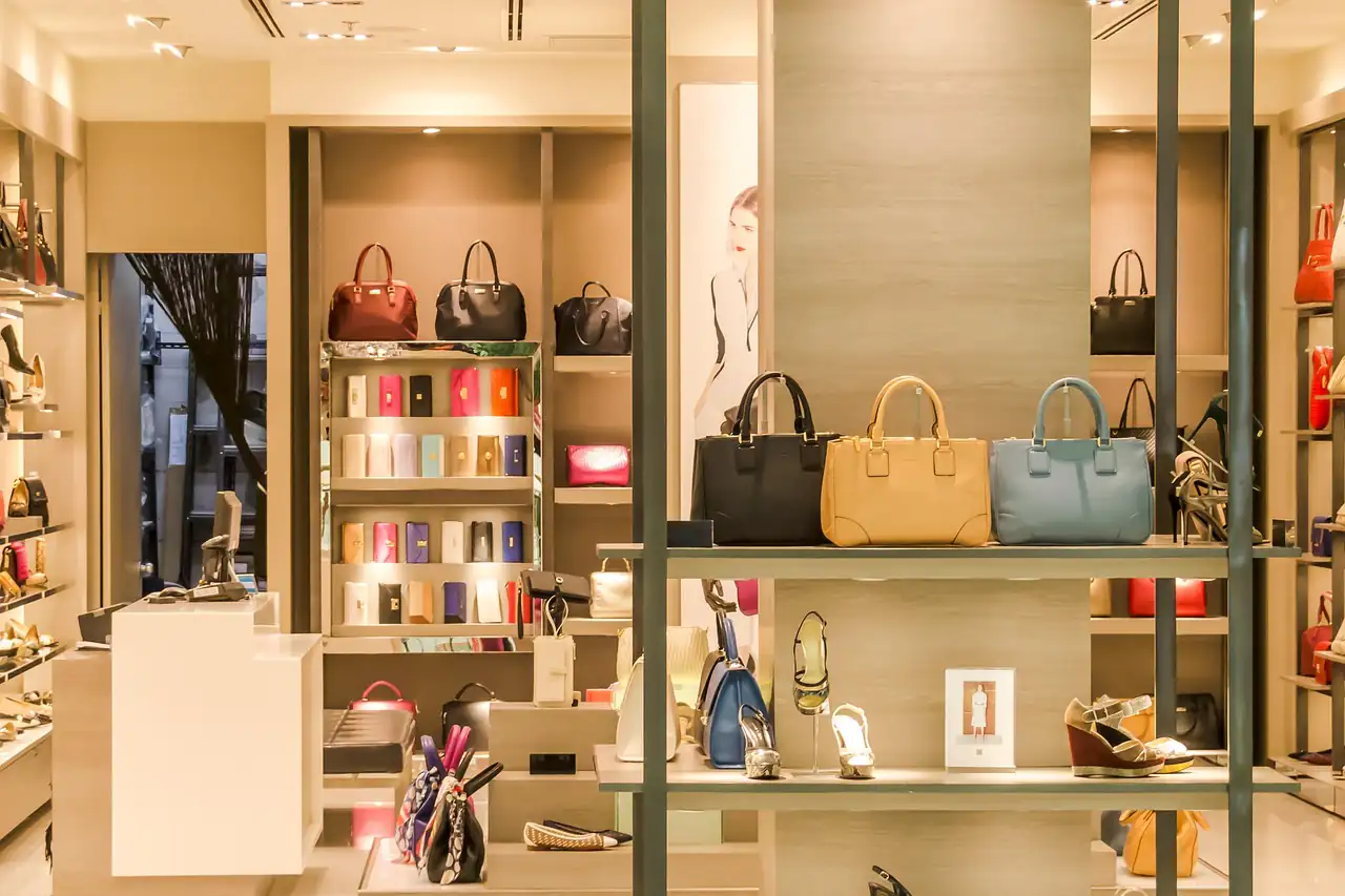 Handbags displayed on shelves in a boutique