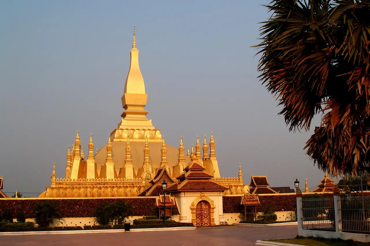 A golden stupa lit by evening sun