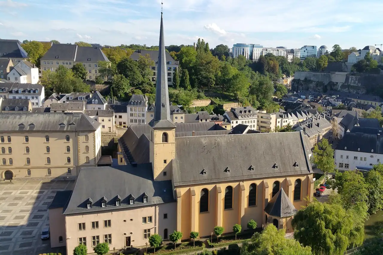 Old town rooftops and a church in a river valley