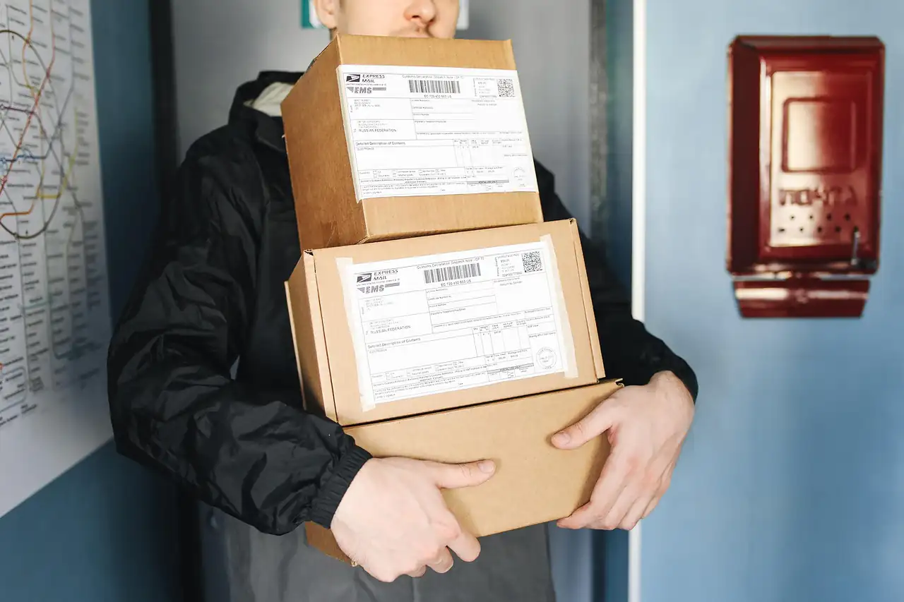 A courier carrying labelled parcels
