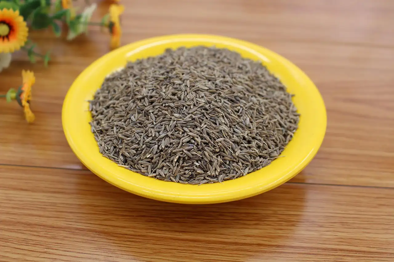 Cumin seeds in a yellow dish