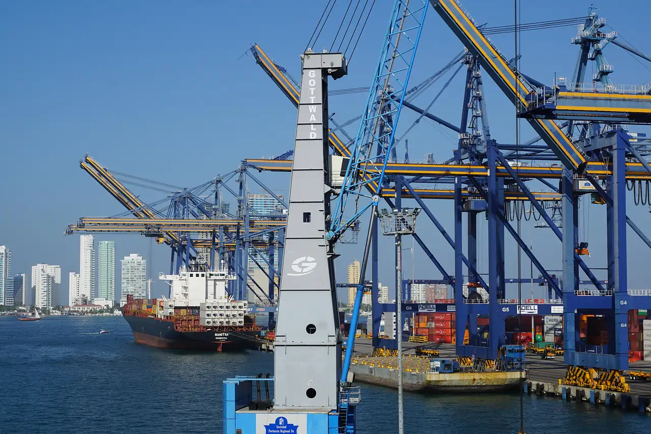 Cranes over a container terminal beside a city