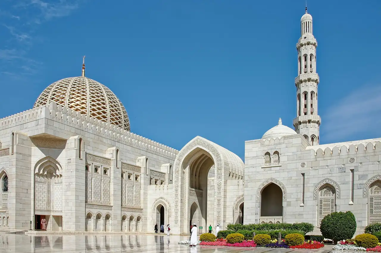 A white stone mosque with a tall minaret
