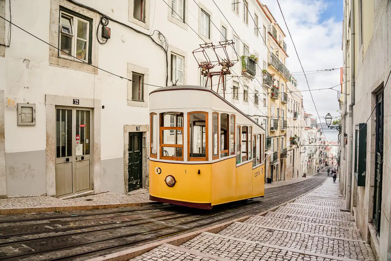 A yellow tram on a narrow street