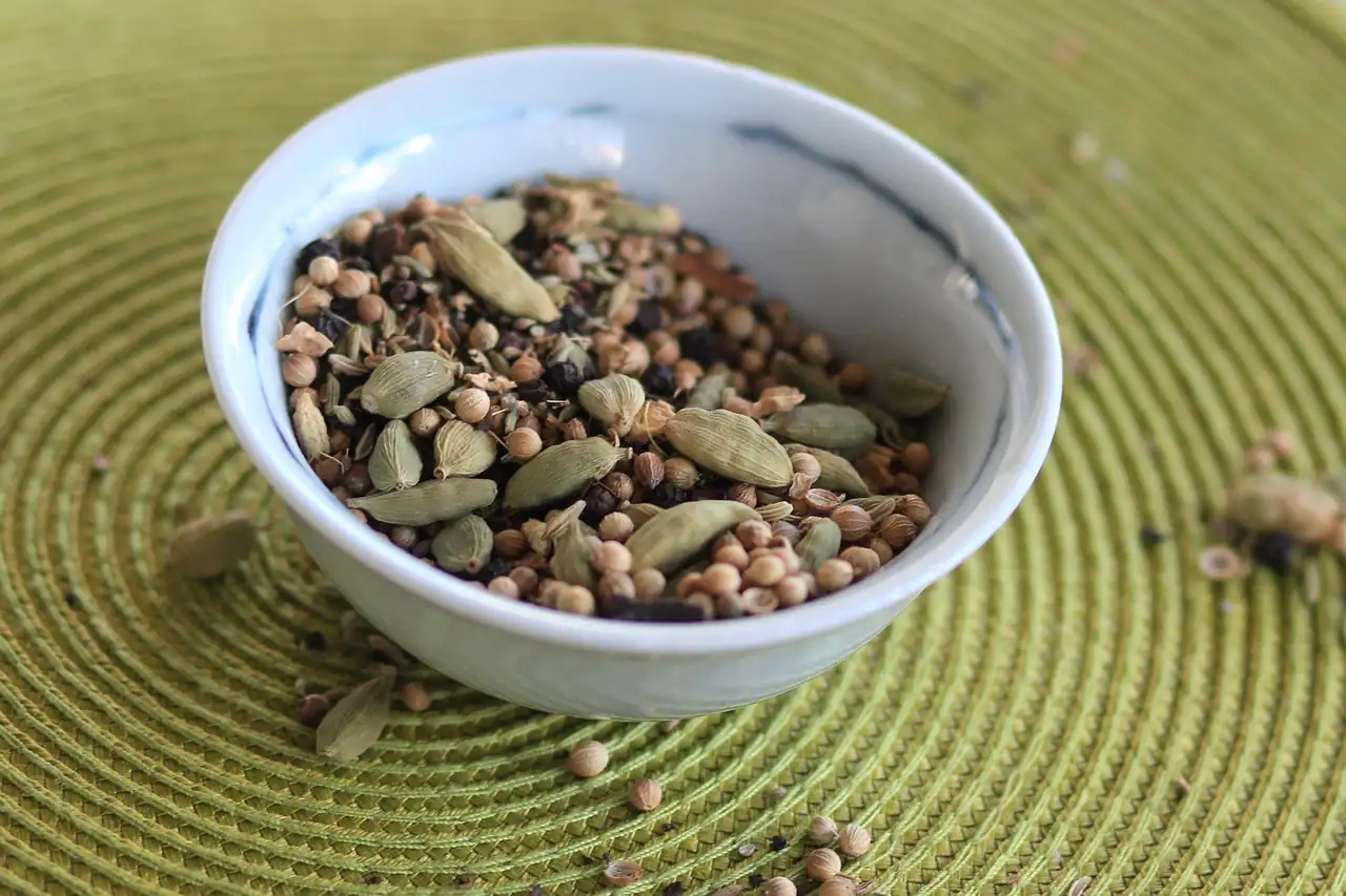 Cardamom pods in a white bowl