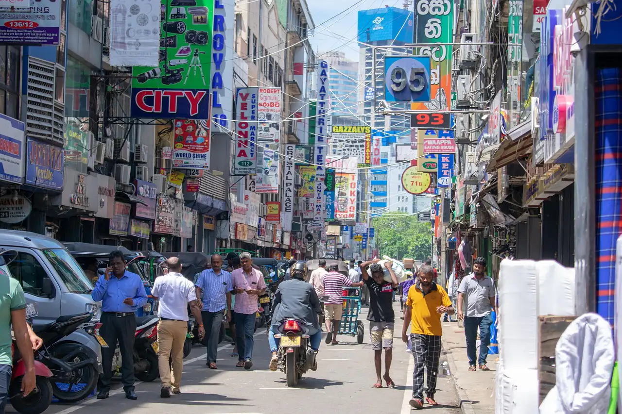 A crowded shopping street lined with signboards