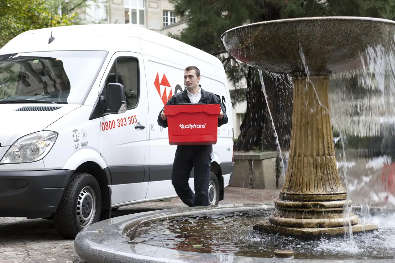 A courier unloading a parcel from a van