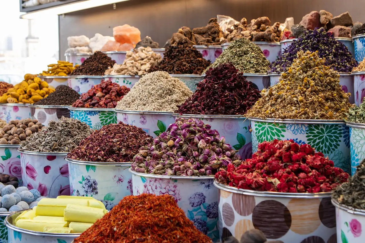 Spices and dried flowers in tubs at a market