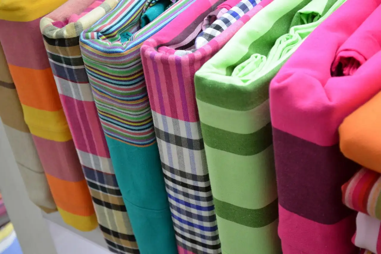 Folded cotton sheets in checks and stripes