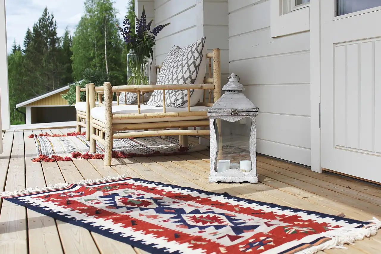 A flat-woven rug on a wooden porch
