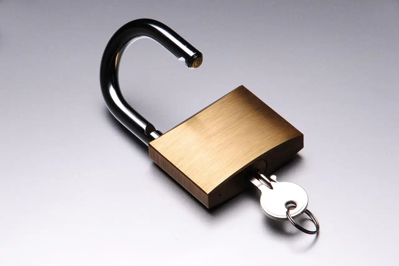 A brass padlock with its key