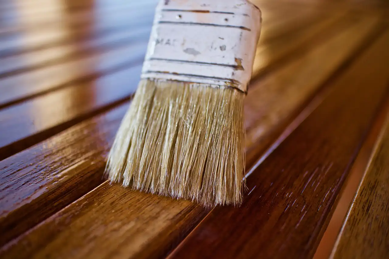 A brush applying finish to a wooden surface