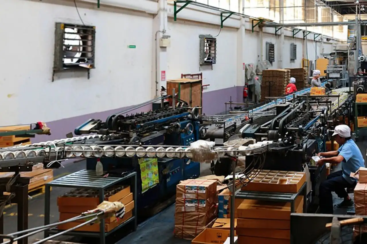 Workers among machines on a busy factory floor