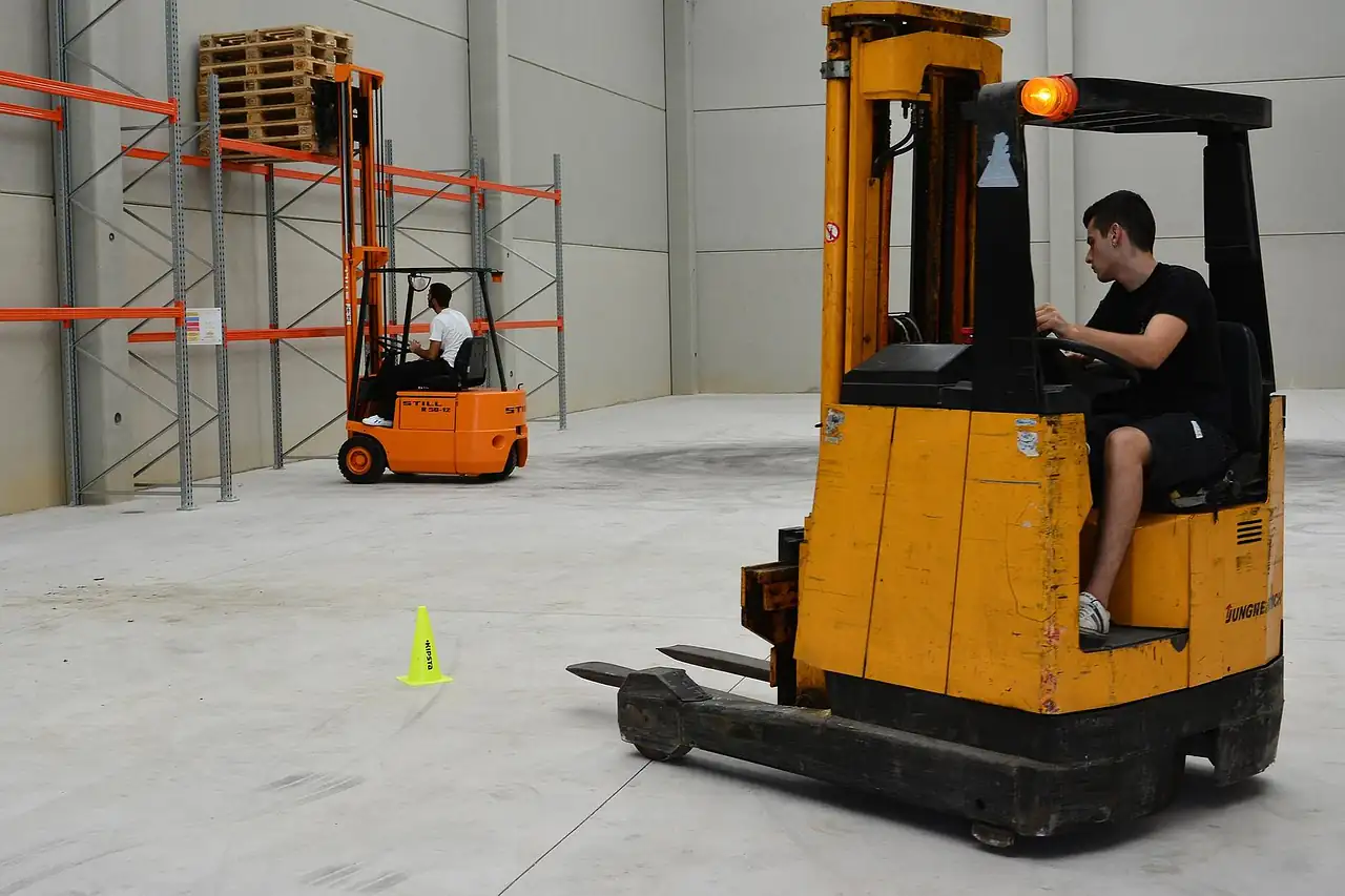 A forklift driver moving through a warehouse