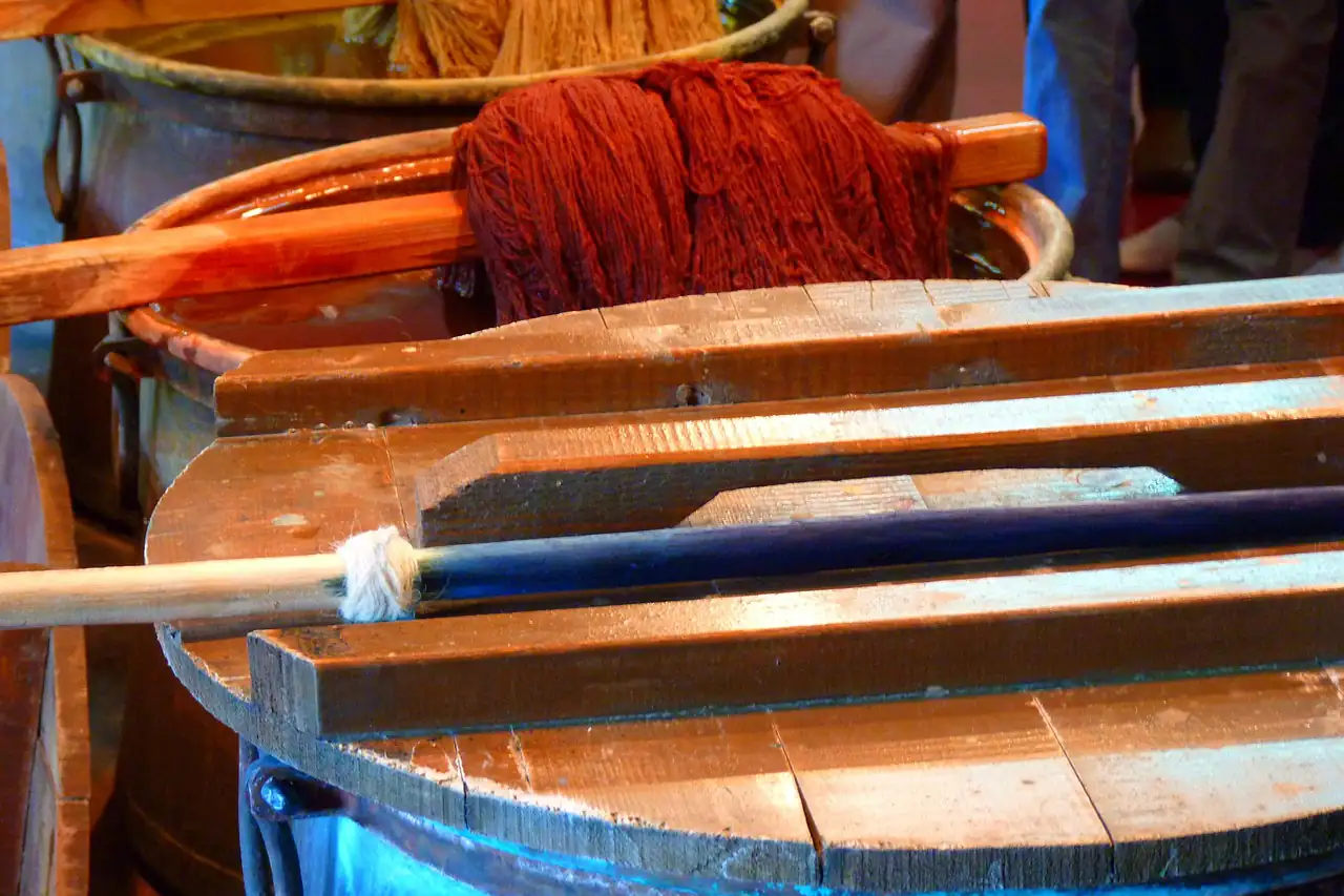Dyed yarn being lifted from a vat