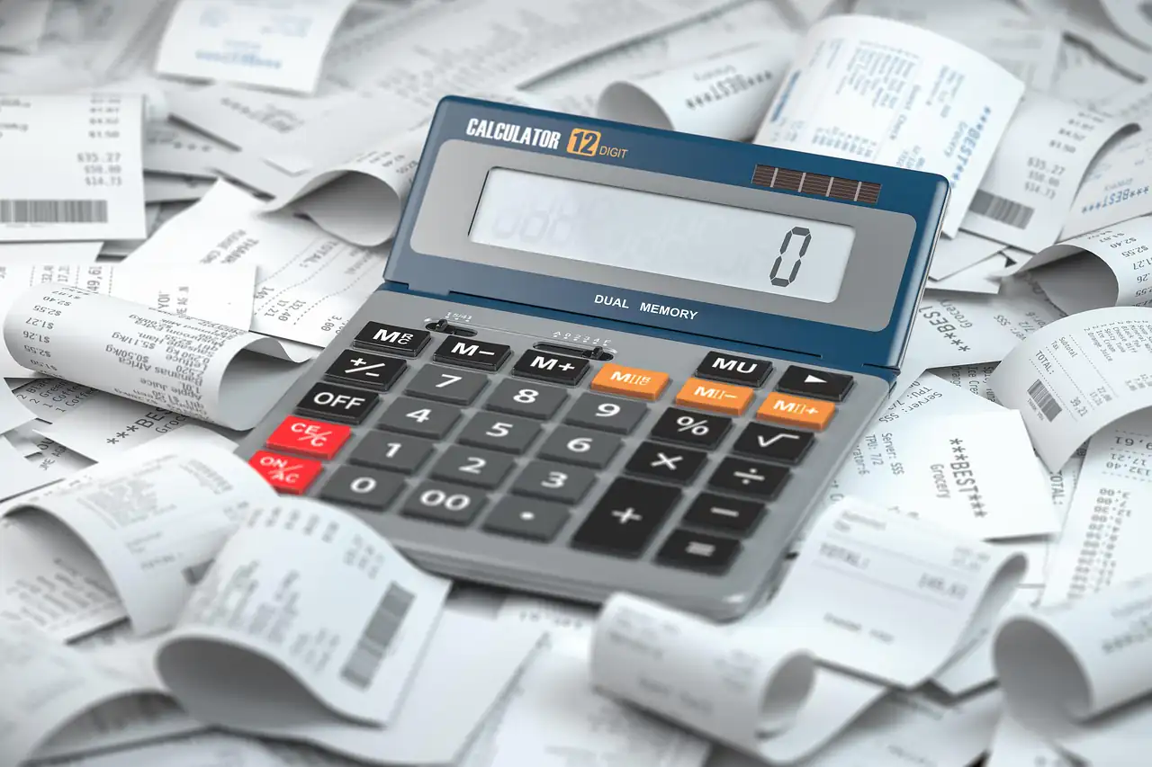 A calculator on a pile of receipts