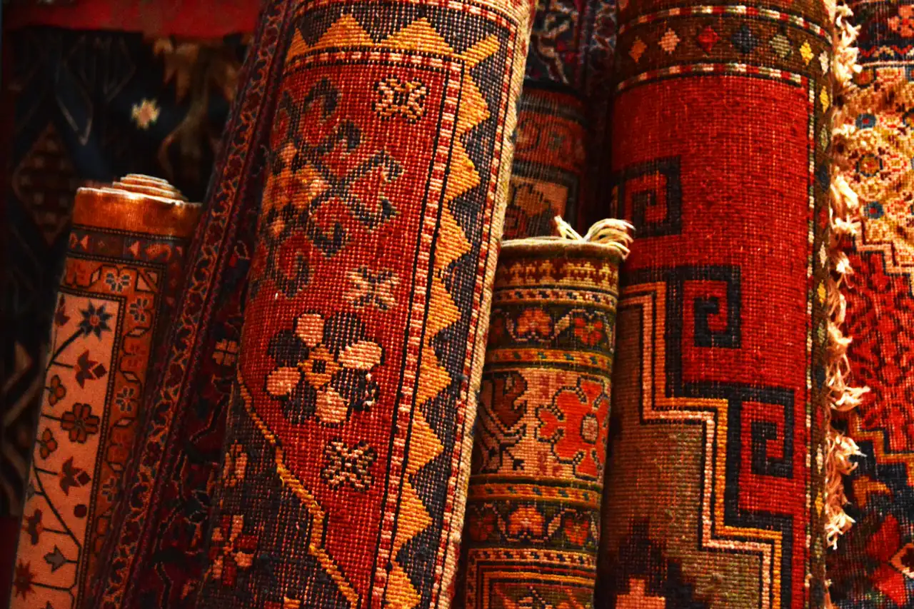 Rolled carpets stacked in a shop